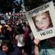 An anti-fascist demonstrator in Boston holds a sign with a photo of Heather Heyer that reads “American Hero” (AP Photo/Michael Dwyer)